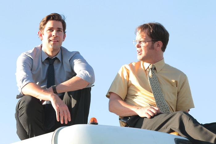 Two men in office attire sitting outdoors, illustrating the concept of fake friends in a toxic relationship.