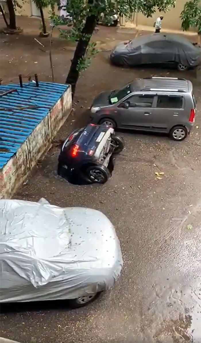 A car flipped on its side in a parking lot, disregarding usual safety regulations.