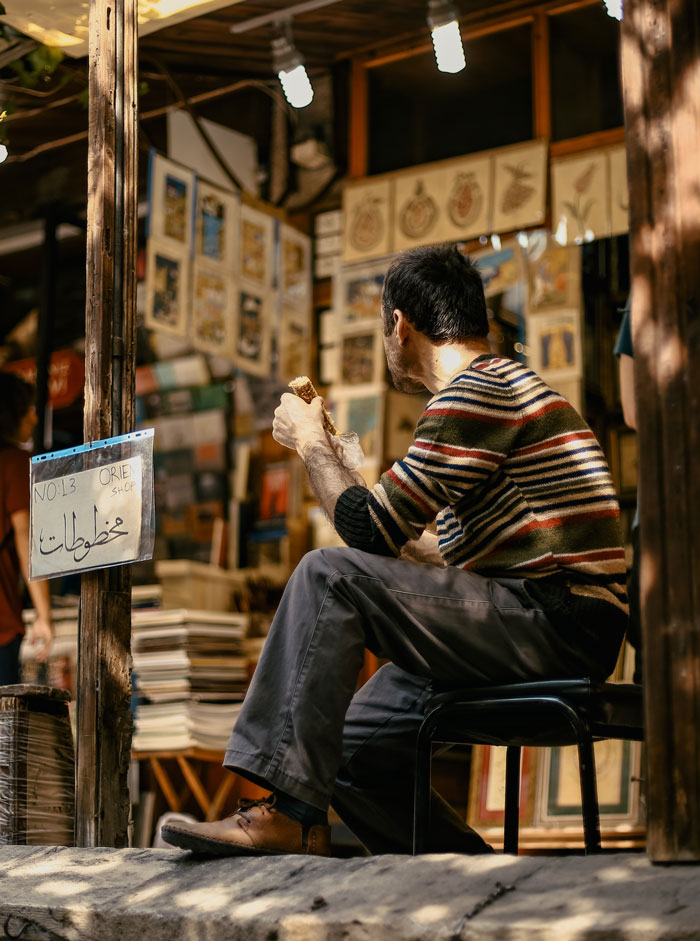 Man sitting in front of store