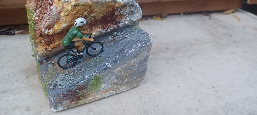 Miniature Cyclist On Mountain