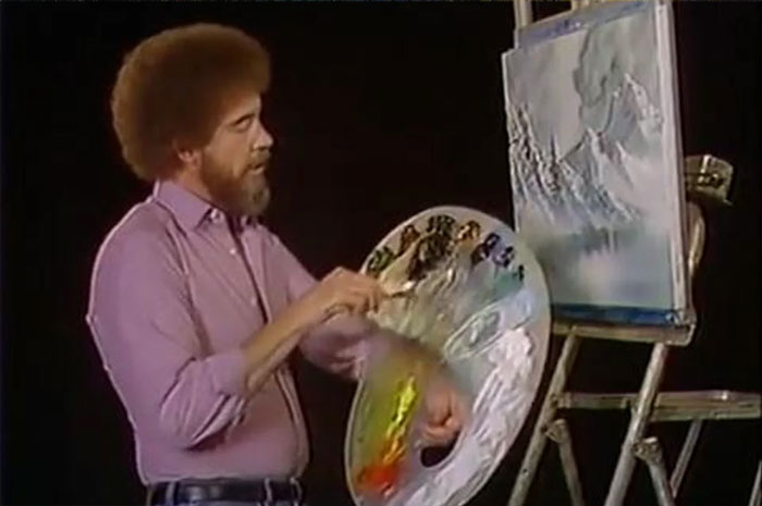 Bob Ross in pink shirt painting a gray landscape, demonstrating curious facts they don't teach in art classes.