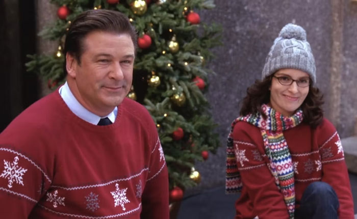 Liz and Jack wearing Christmas sweaters 