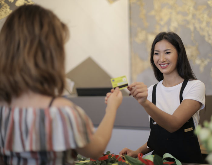 Woman paying with credit card at the store