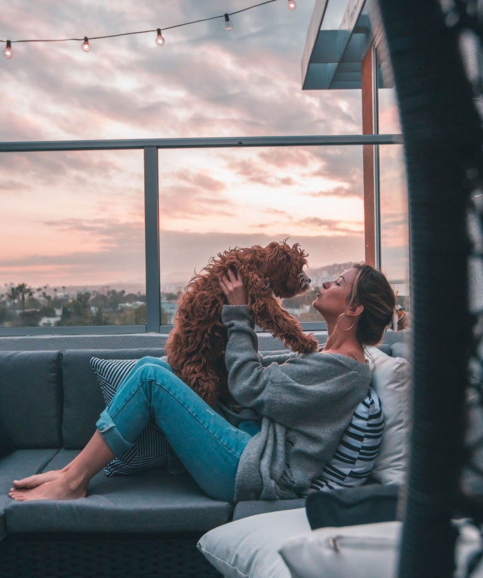 Woman kissing her dog 