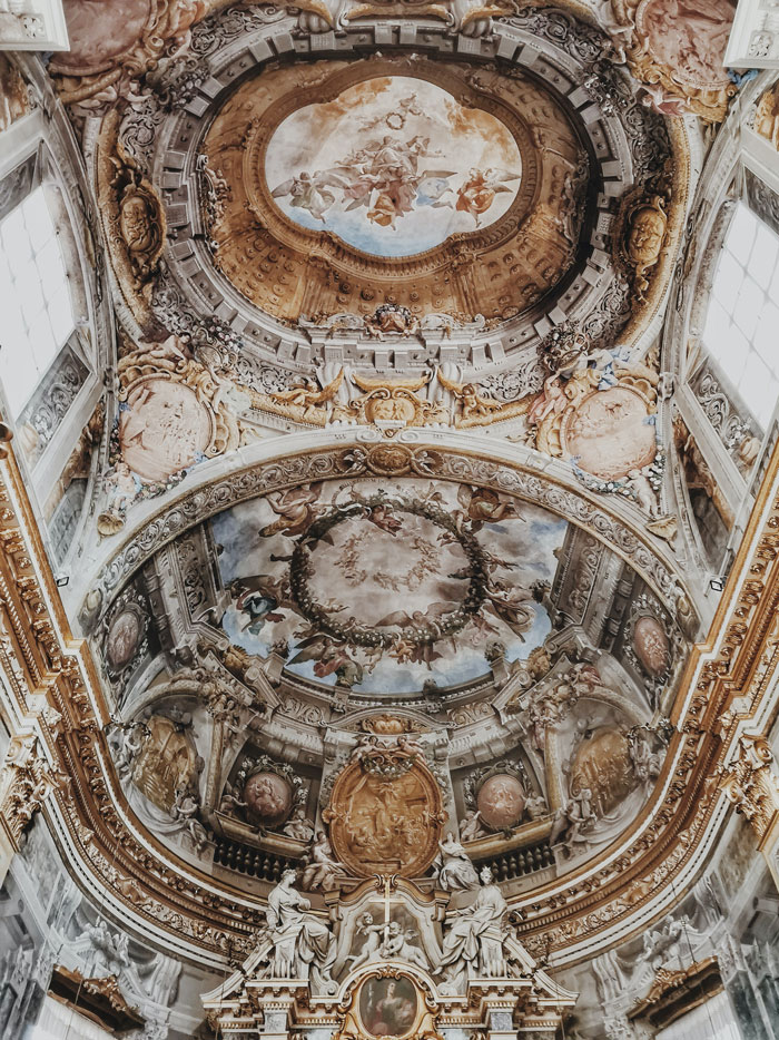 Baroque ceiling fresco with ornate sculptures and detailed artistic elements showcasing art facts and techniques.