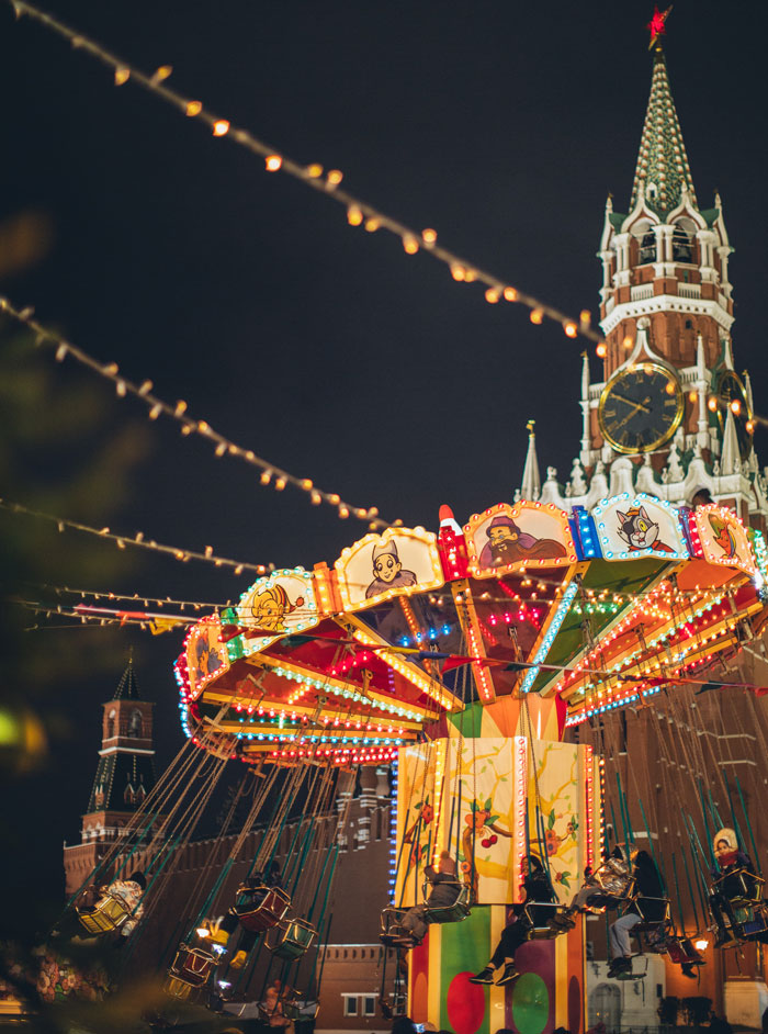 Colorful luminous carousel in square at night