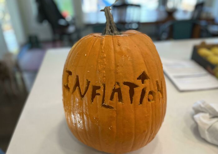 Pumpkin carved with the word inflation, capturing a funny Halloween moment kids made parents laugh during Halloween.