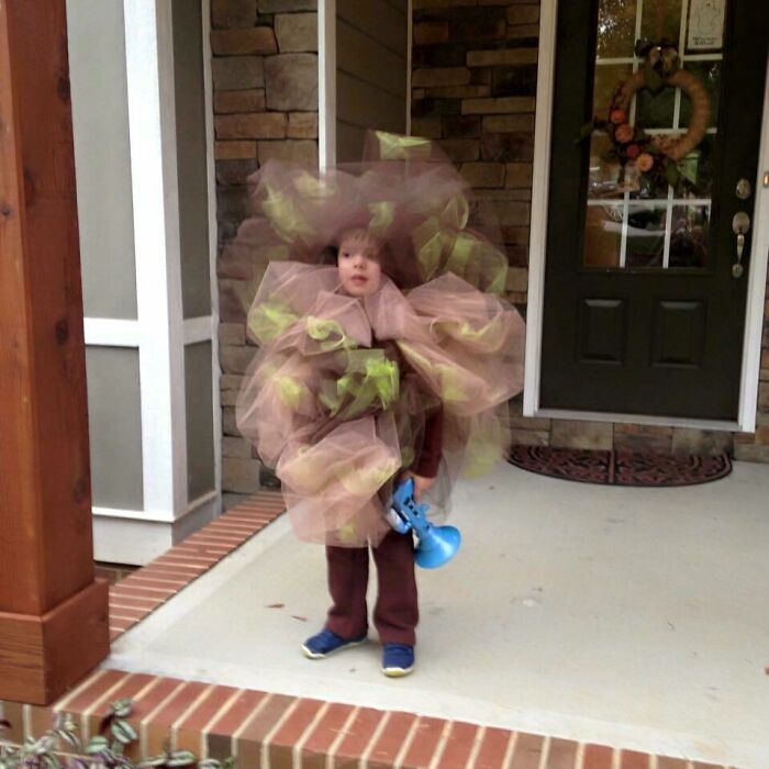 Child in a creative Halloween costume making parents laugh hard, capturing the joy of kids during Halloween moments.