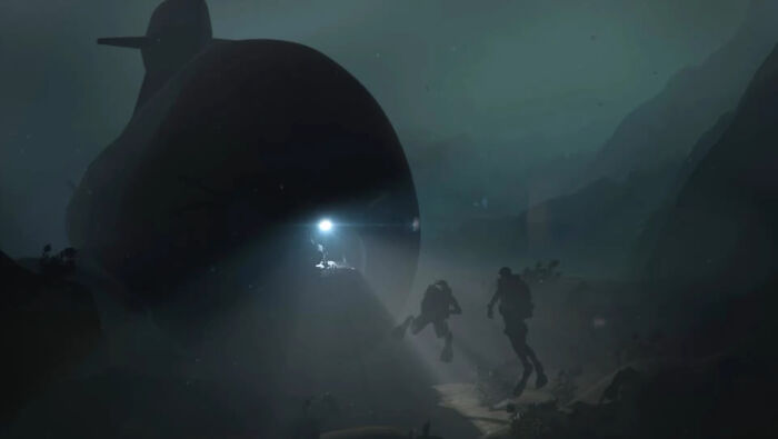 Underwater scene with divers near a dark submarine, capturing one of the frightening pics that make us fear the ocean.