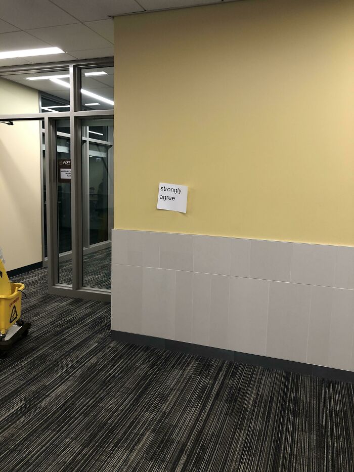 Piece Of Paper Taped Up On Wall That Says “Strongly Agree”