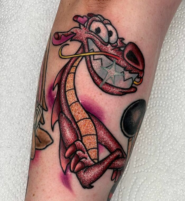 Glitter tattoo of a cheerful cartoon dragon with bright colors and sparkly details.