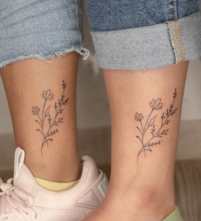 BFF tattoo design on ankles featuring delicate floral line art, symbolizing friendship.