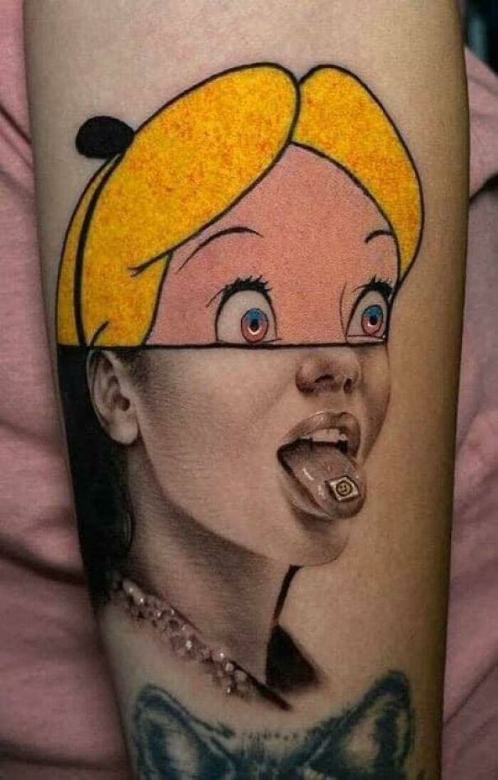 Creative tattoo design combining cartoon and realistic elements on a person's arm.