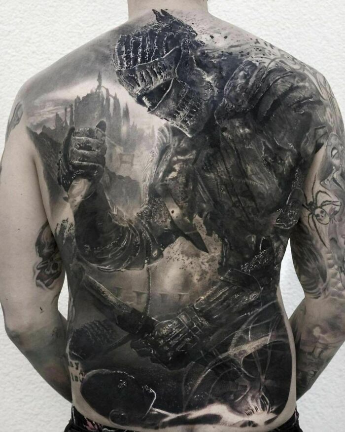 Detailed knight design tattoo covering entire back, showcasing intricate artistry and creativity.