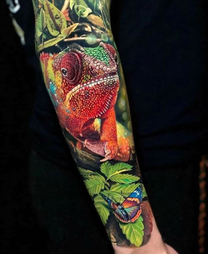Realistic chameleon tattoo design featuring vibrant colors and detailed artwork on an arm.