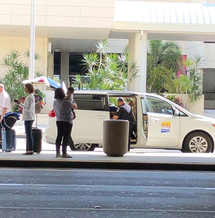 Fort Myers Officer Helping A Woman Secure Her Car Seat In A Cab. Solid Guy