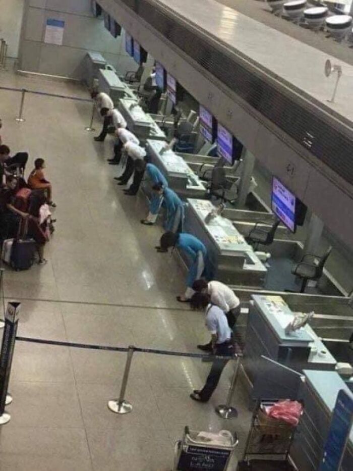 Staff For Japan Airlines In Vietnam Bow To Passengers As Flight Was Delayed Because Of Storm