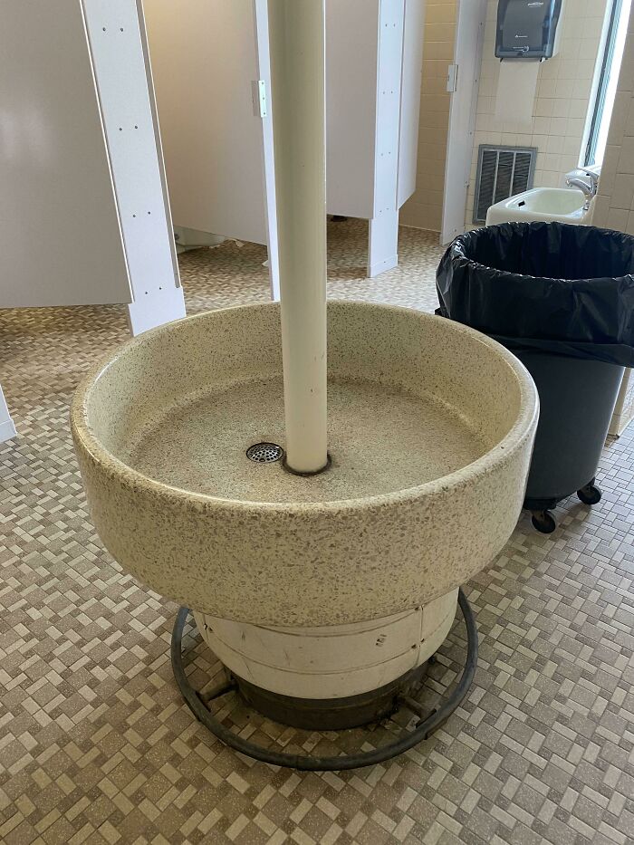 ¿Qué es este gran tubo redondo en medio del baño de mujeres? Está en un baño viejo y no parece tener agua… solo es un gran cilindro con un desagüe 