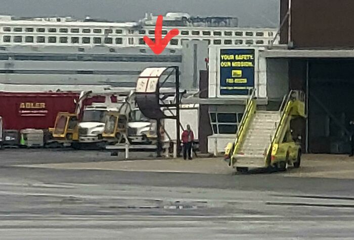 At Boston Airport There Are Multiple Half Circle Devices On A Stand Which Are Made From Shiny Sheet Metal. There Are A Bunch Of Random Holes In Most Of The Panels That Look Like A Shotgun Blast