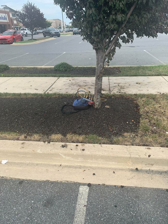 Backpack With Pressure Gauges And Tubing Coming Out Of It/On Top Of It