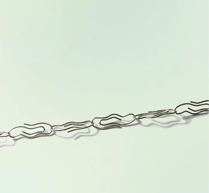 Unusual and conceptual product design shown as a minimalist, artistic chain of uniquely shaped metal links.