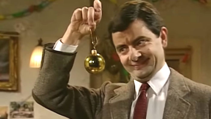 Mr. Bean holding a Christmas tree ornament 