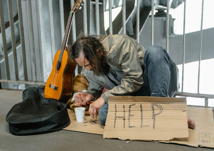 Homeless man counting coins