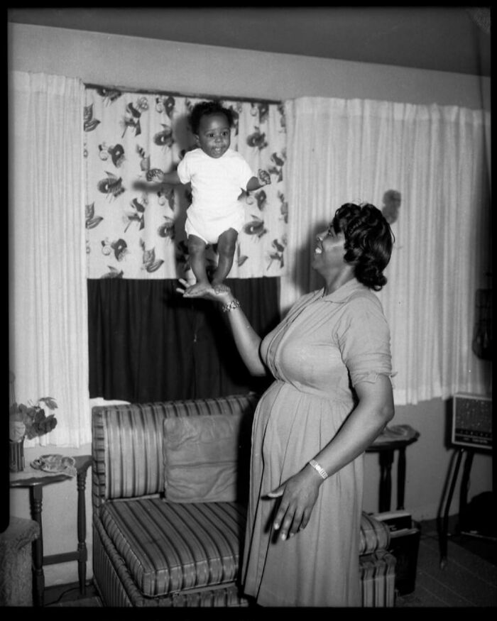 A Small Girl Balances On Her Mother’s Hand In Pittsburgh . Taken In The Mid-1900s