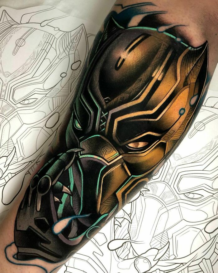 Marvel tattoo of Black Panther on arm, showcasing intricate details and vibrant colors.