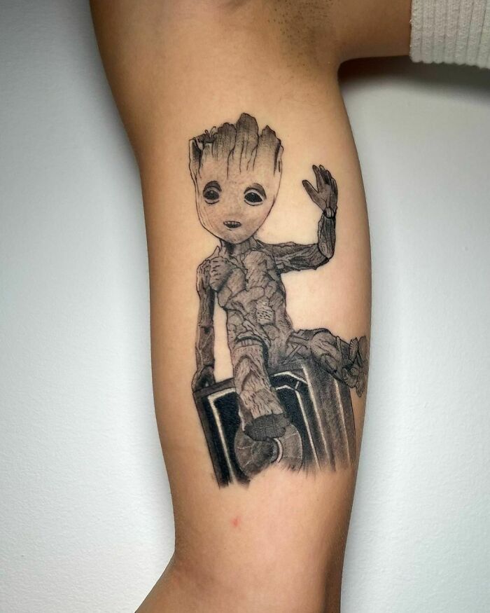 Groot tattoo on arm, showcasing detailed Marvel artwork.
