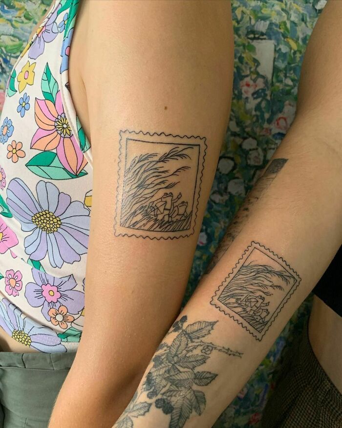 Two friends showcasing matching BFF tattoos featuring a scenic design on their arms.