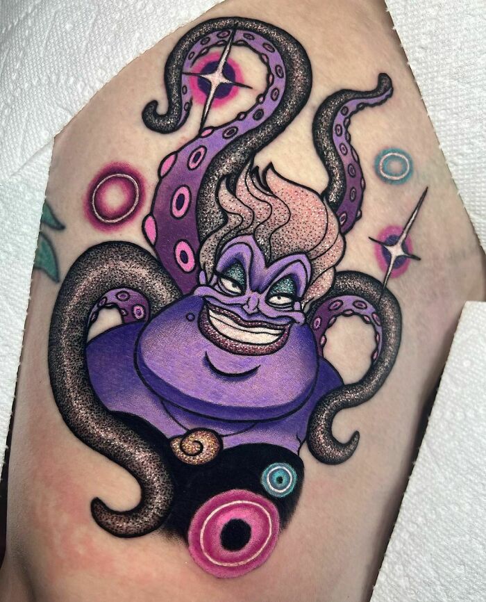 Colorful octopus-themed glitter tattoo with vibrant purple hues on skin.