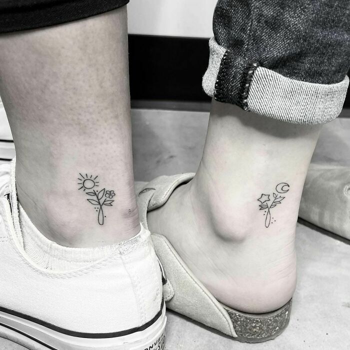 Matching BFF tattoos on ankles featuring sun, moon, and floral designs, symbolizing friendship and unity.