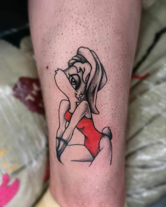 Cartoon tattoo featuring a character in a red outfit, capturing childhood favorites on skin.