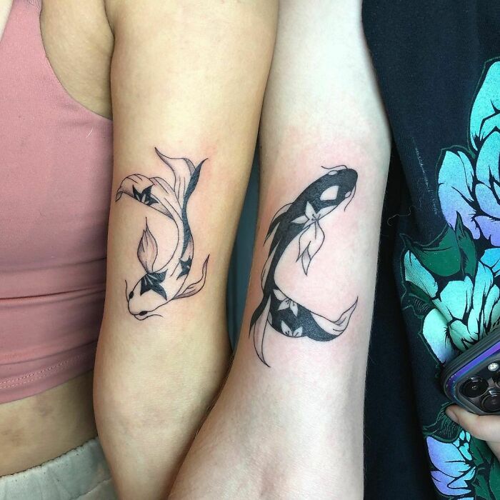 Koi fish tattoos on two arms symbolizing best friend tattoos to commemorate friendship.