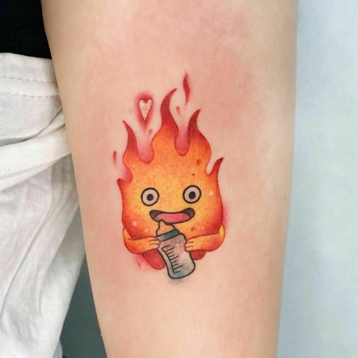 Cartoon tattoo of Calcifer from Howl's Moving Castle, showcasing a bright, fiery design with nostalgic appeal.