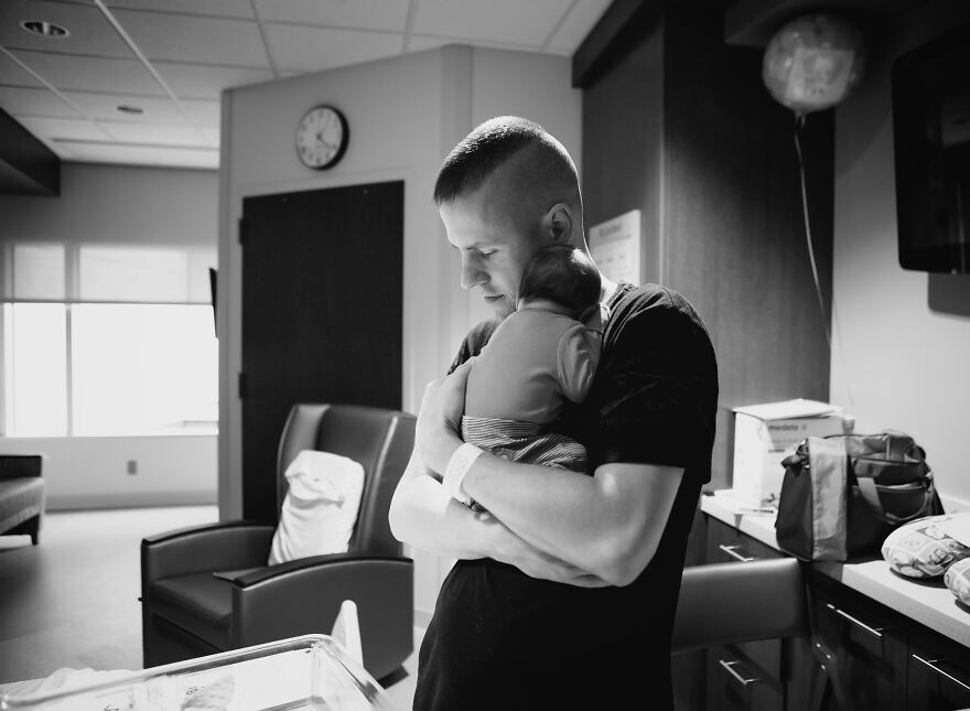 A photograph of a newborn with their dad