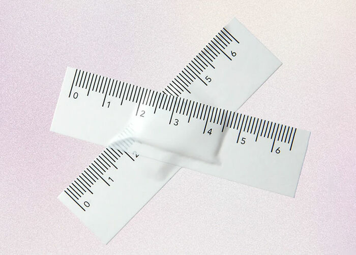 Unusual conceptual product design featuring intersecting rulers with a three-dimensional distortion in the center on light background.