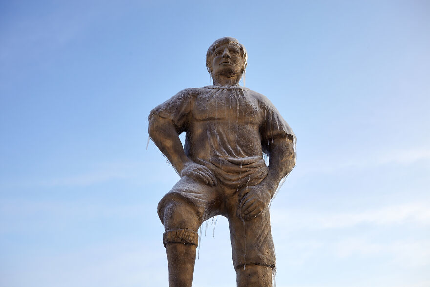Sculptures Of Athletes Covered With Ice After An Icy Rain