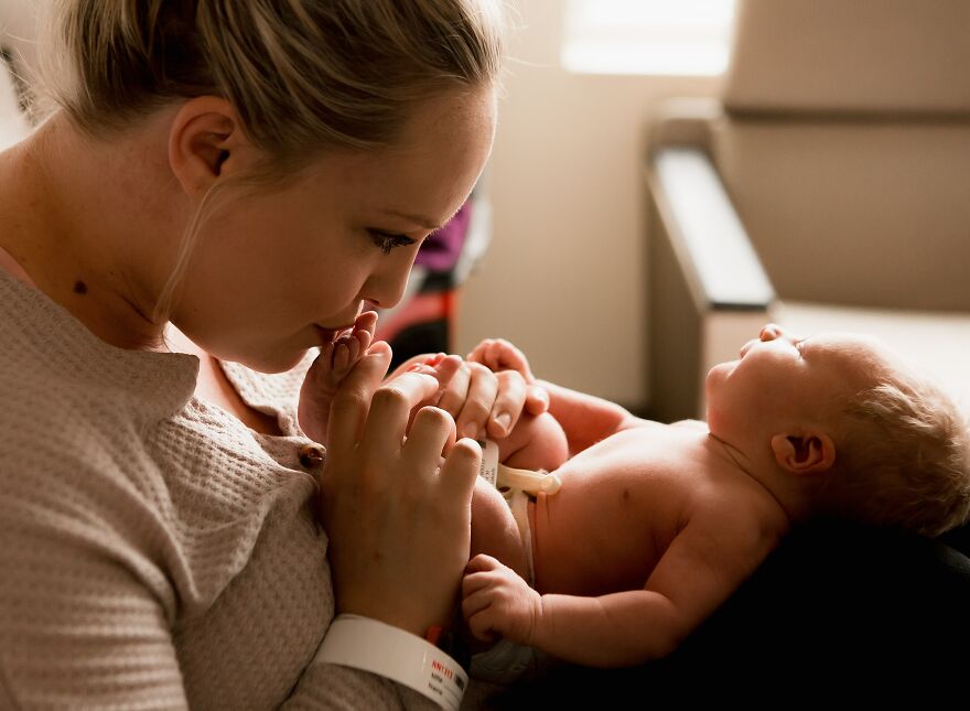 A photograph of a newborn with their mom