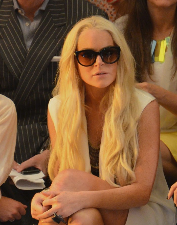 Lindsay Lohan wearing white clothes sitting and looking