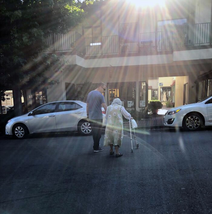 Helping An Elderly Woman Cross The Street. This Is Such A Kind And Sweet Moment Captured
