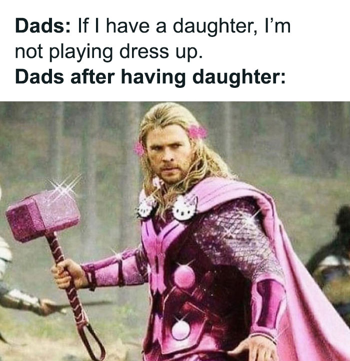 Dad in pink superhero costume, holding a sparkling hammer, showcasing humor and transformation in fatherhood.