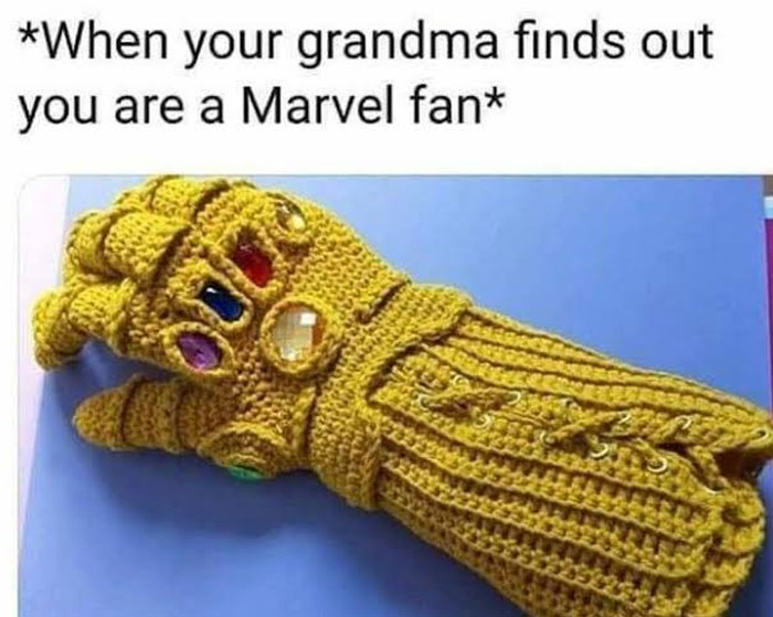 Crocheted Infinity Gauntlet on blue background, embodying wholesome meme humor about being a Marvel fan.