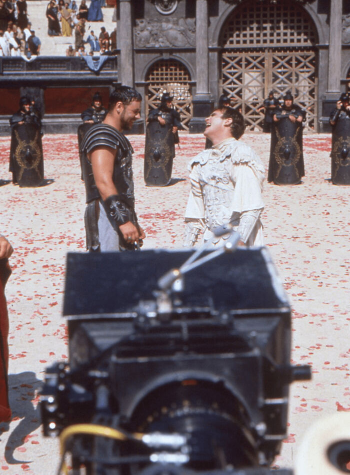 Russell Crowe, Cigarette In Hand, And Joaquin Phoenix Share A Joke While Filming Their Final Duel For Gladiator (1999)