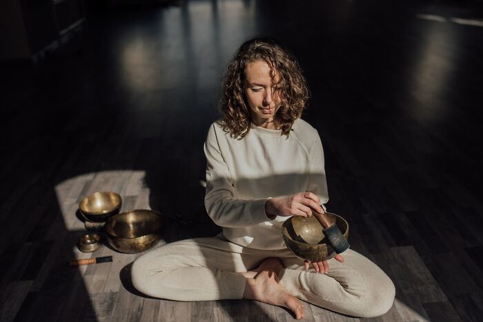 Woman Playing Tibetan Bowls