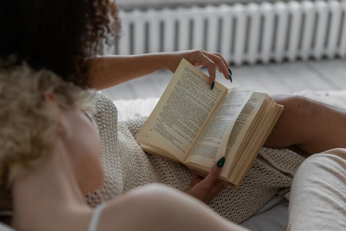 Two Women Reading A Book In Bed 