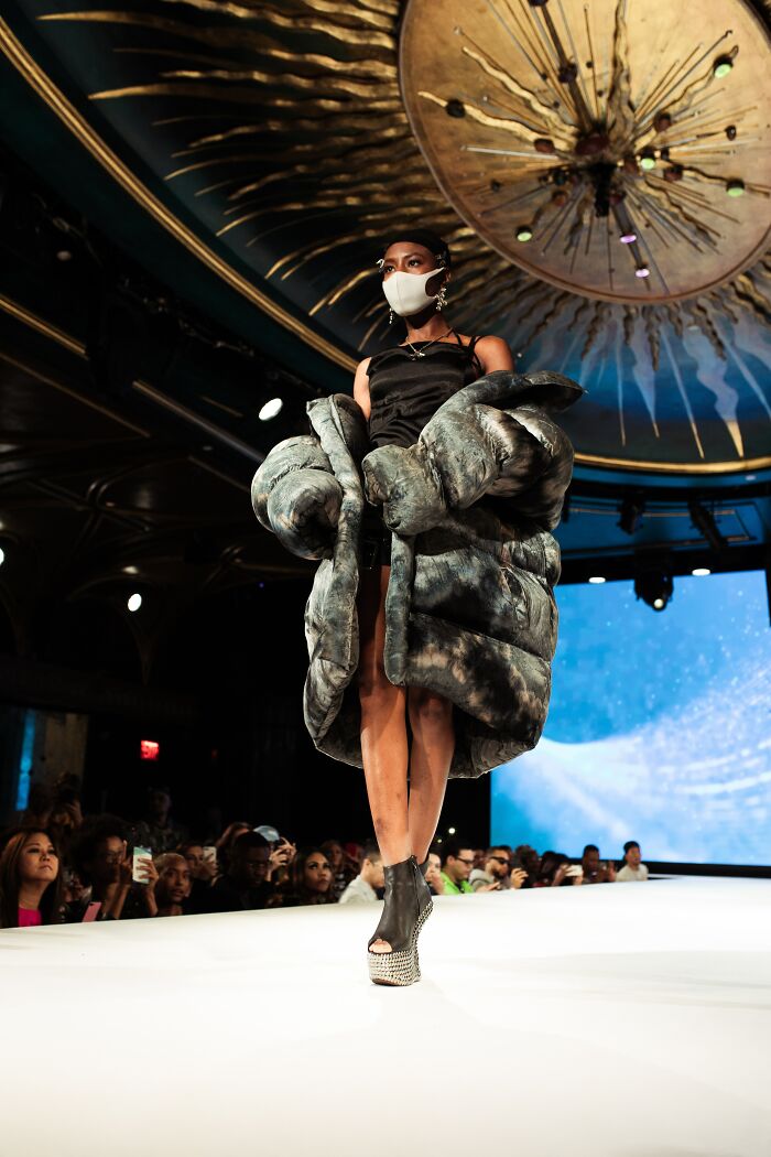 Model In A Fashion Show With A Face Mask On 
