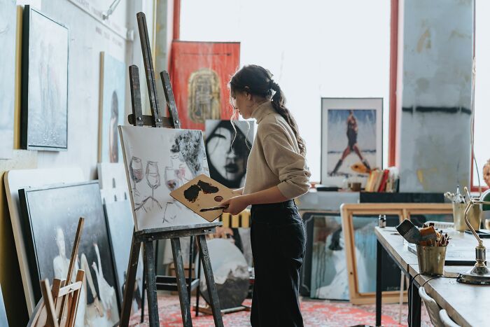 Woman Painting In On Canvas In Studio