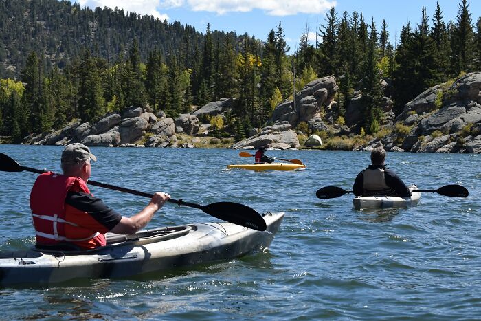 People Kayaking In River 